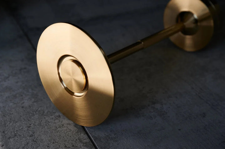 Luxuriöser Tischlampen Standfuß aus gebürstetem Messing auf grauem Untergrund